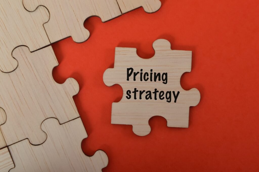 The word PRICING STRATEGIES is written on jigsaw puzzle.
